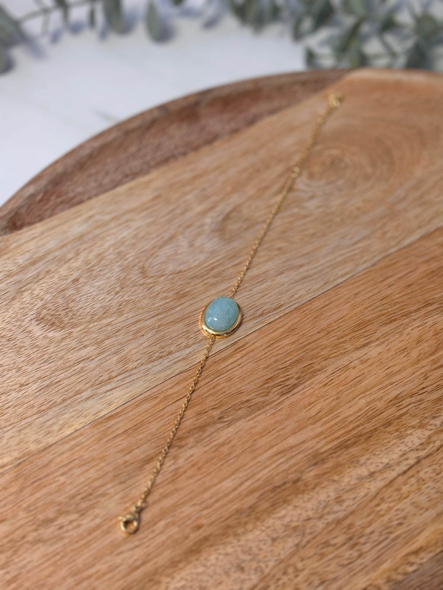 Gold chain bracelet with oval stone